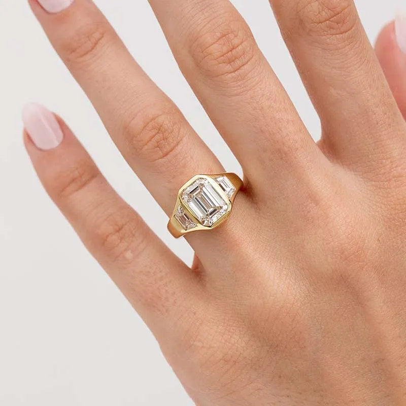 4.5ct three stone emerald cut all over bezel set yellow gold engagement ring
